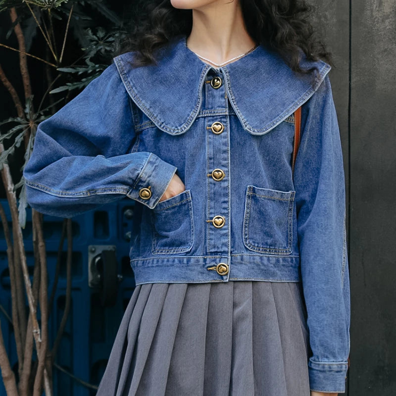 A fashionable women's denim jacket with a Peter Pan collar and button-up design, featuring practical pockets for a stylish and versatile look.