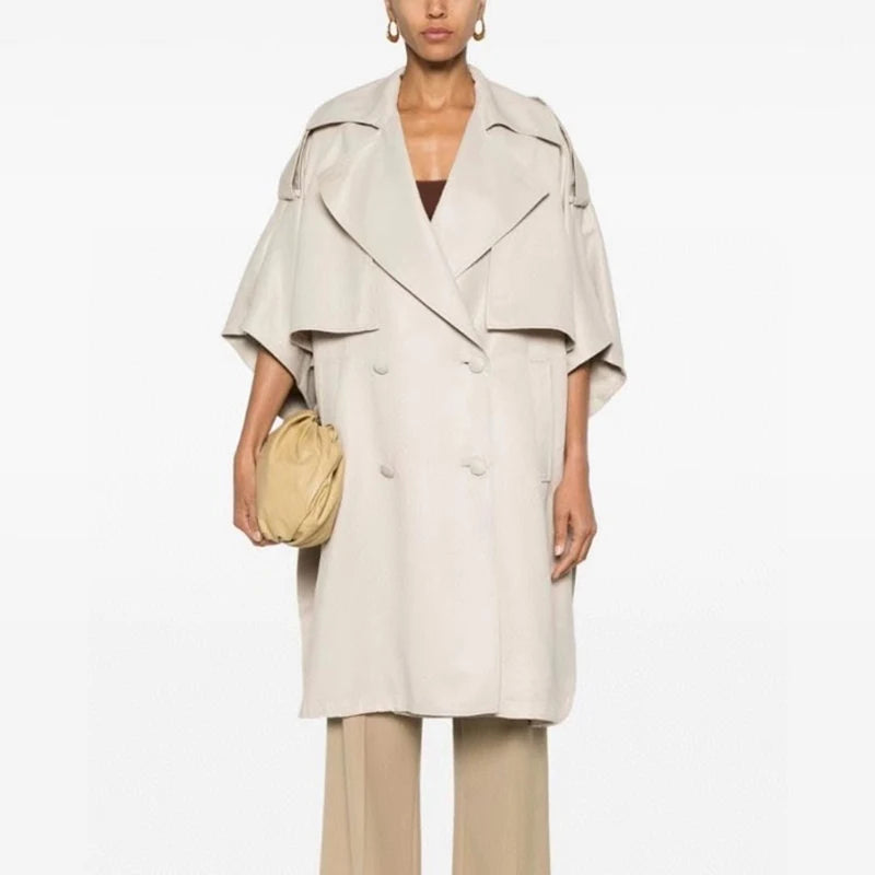 Designer Double-Breasted Cape with soft draping and snap-button short sleeves, inspired by 80s trench coats for Fall/Winter.