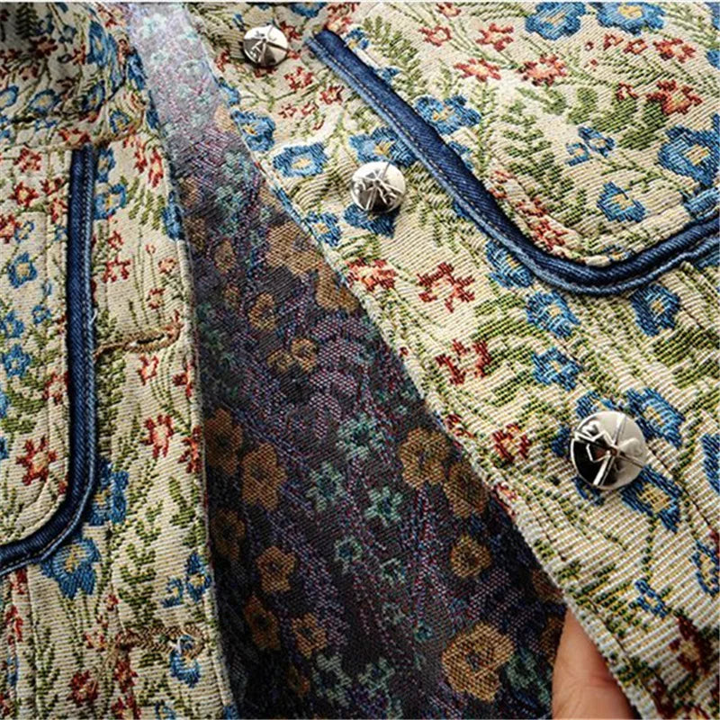 Close-up of a women's denim jacket featuring vintage jacquard embroidery, big pockets, and a loose fit for a chic retro look.