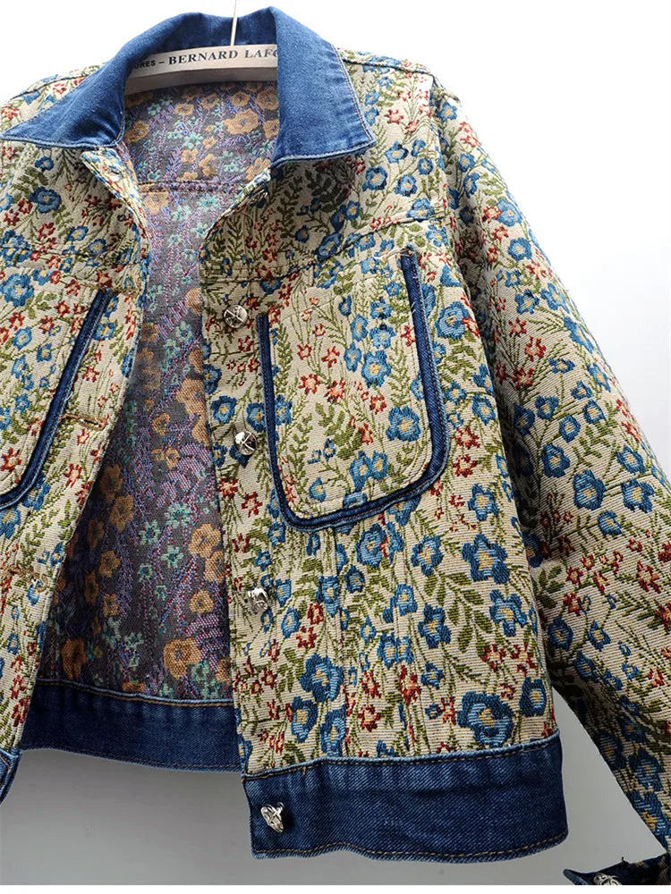 Close-up of a women's denim jacket featuring vintage jacquard embroidery, big pockets, and a loose fit for a chic retro look.