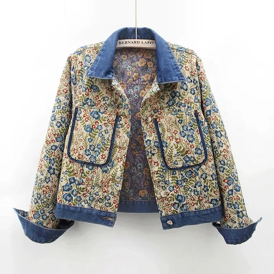 Close-up of a women's denim jacket featuring vintage jacquard embroidery, big pockets, and a loose fit for a chic retro look.