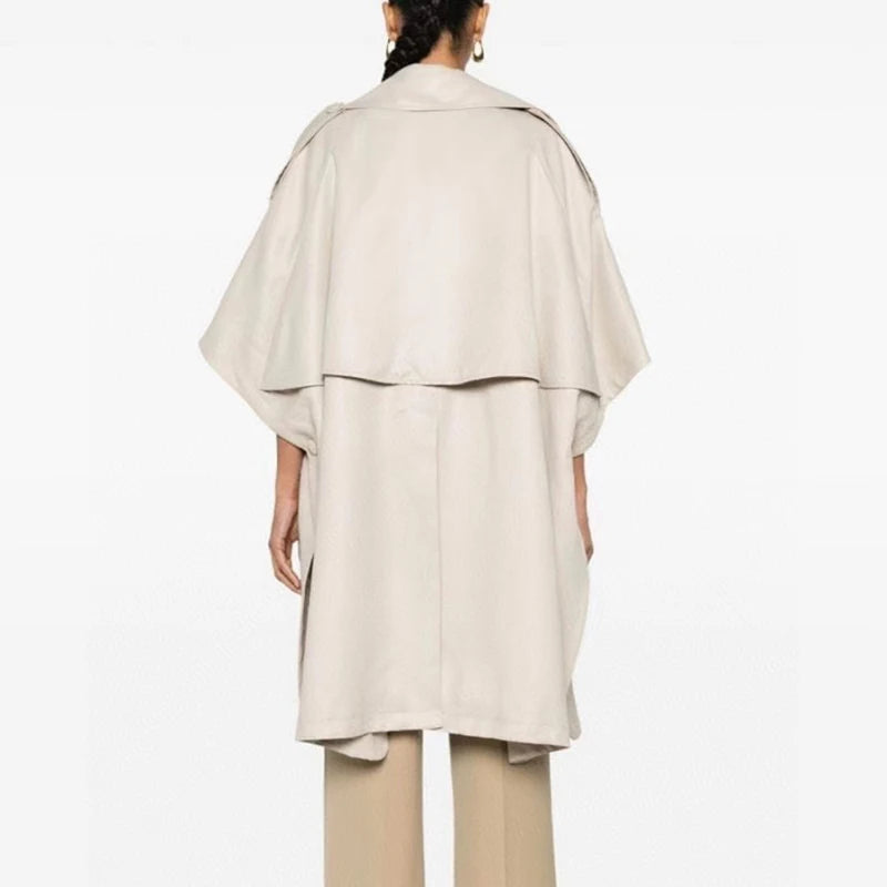 Designer Double-Breasted Cape with soft draping and snap-button short sleeves, inspired by 80s trench coats for Fall/Winter.