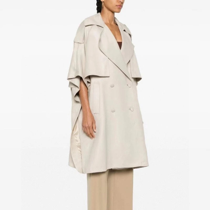 Designer Double-Breasted Cape with soft draping and snap-button short sleeves, inspired by 80s trench coats for Fall/Winter.